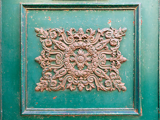 Image showing rusty ornamental decoration at a green door in Italy