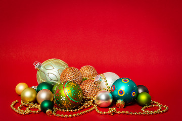 Image showing Christmas decoration glass balls on red background