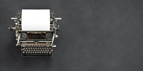 Image showing Vintage typewriter with blank sheet of paper retro technology