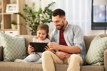 Image showing father and daughter with tablet computer at home