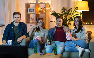 Image showing friends with beer and popcorn watching tv at home