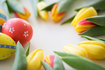 Image showing close up of colored easter eggs and tulip flowers