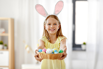 Image showing happy girl with colored easter eggs at home