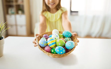 Image showing close up of girl with easter eggs in wicker basket