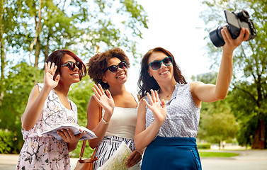 Image showing women with map travelling and recording video blog