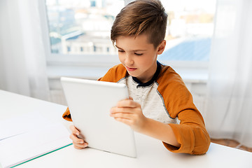 Image showing student boy with tablet pc and notebook at home