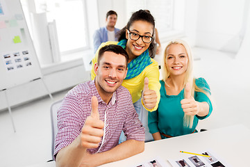 Image showing creative team showing thumbs up at office