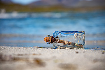 Image showing Message in the bottle against the Sun setting down