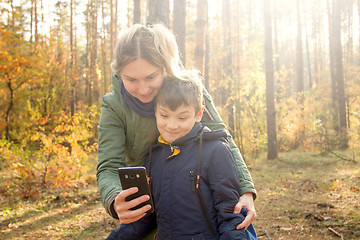 Image showing Son and Mother are making selfie in the Park