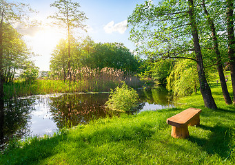 Image showing Wooden bench near river