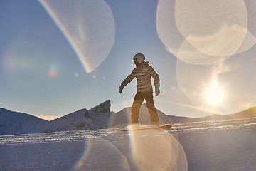 Image showing Snowboarder in sun flare, water drops on lens