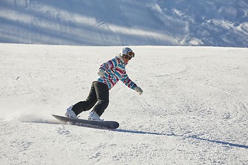 Image showing Female snowboarder on the slope