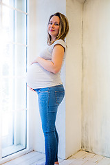 Image showing Beautiful pregnant woman standing near window