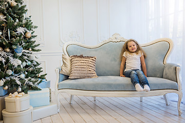 Image showing Beautiful girl sitting on the sofa near