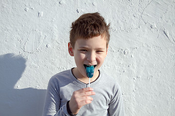 Image showing Boy with blue lollipop