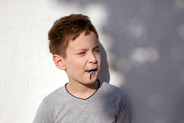 Image showing Boy with blue lollipop