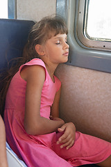 Image showing Tired girl fell asleep in an electric train