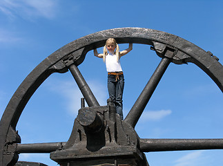 Image showing Little girl and large wheel