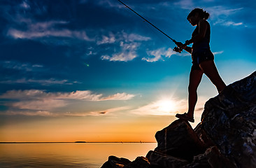 Image showing Woman fishing on Fishing rod spinning in Norway.