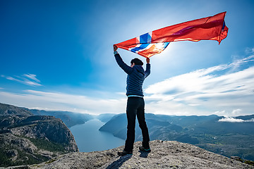 Image showing Woman with a waving flag of Norway on the background of nature