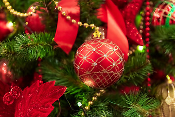 Image showing Red Christmas ball hanging on Christmas tree.