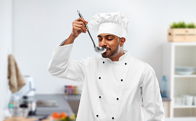 Image showing indian chef tasting food from ladle at kitchen
