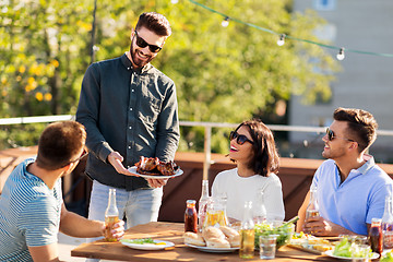 Image showing friends at bbq party on rooftop in summer