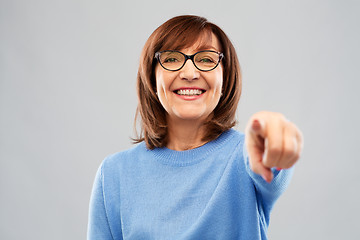 Image showing senior woman in glasses pointing finger to you