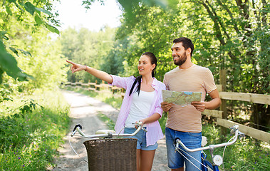 Image showing couple with map and bicycles at country in summer