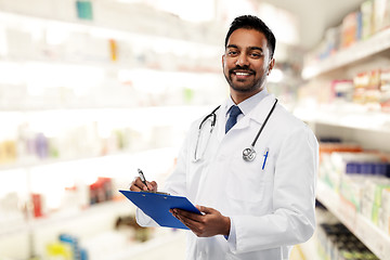 Image showing indian male doctor with clipboard and stethoscope