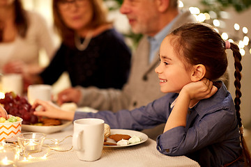 Image showing happy girl having tea party with family at home