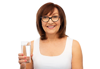 Image showing senior woman in glasses with glass of water
