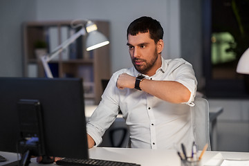 Image showing businessman using voice command on smart watch