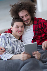 Image showing couple relaxing at  home with tablet computers