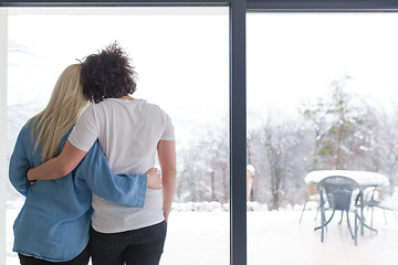 Image showing young couple enjoying morning coffee by the window