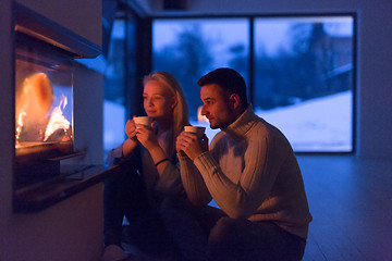 Image showing happy couple in front of fireplace