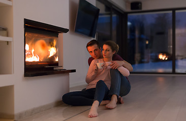 Image showing happy couple in front of fireplace