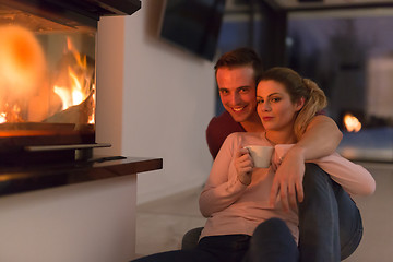 Image showing happy couple in front of fireplace