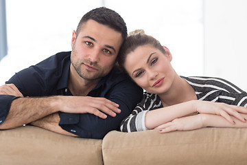 Image showing Portrait of young couple sitting on sofa