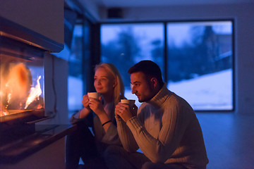 Image showing happy couple in front of fireplace