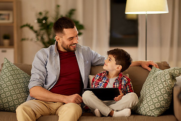 Image showing father and son with tablet pc playing at home