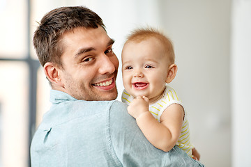 Image showing happy father holding little baby daughter at home