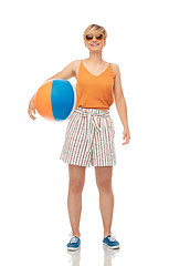 Image showing smiling teenage girl in sunglasses with beach ball