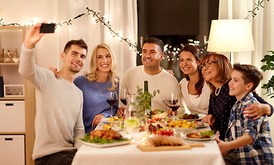 Image showing family having dinner party and taking selfie