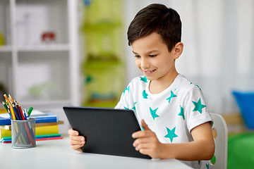 Image showing student boy with tablet pc and notebook at home