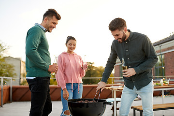 Image showing happy friends having bbq party on rooftop