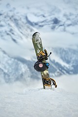 Image showing Snowboard on a mountain top