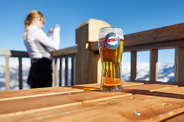 Image showing Having a beer on a terrace with scenic view, winter in the mountains