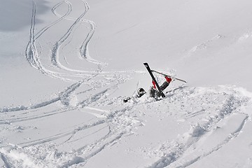 Image showing Skier falls in deep snow