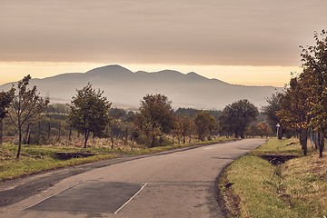 Image showing Autumn road through autumn landscape